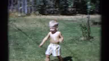 Disneyland California (1959): Two Kids Are Walking Around The Yard That Has Green