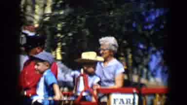 Disneyland California (1959): Boy And Woman Wearing Blue Shirts Ride On Firetruck