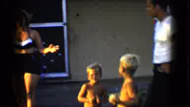 Disneyland California (1959): Mother And Two Sons Playing Outside In The Garden On