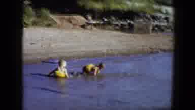 Disneyland California (1959): Two Boys Play In Fresh Water Outdoors Wearing Yellow