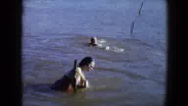 Disneyland California (1959): A Woman And Child With A Pet Swim In Muddy Water