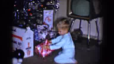 Disneyland California (1959): Little Boy Opening Christmas Present Around