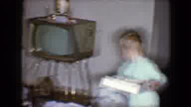 Disneyland California (1959): Boy Wearing Blue Pajamas Opens Gift Next To