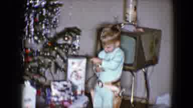 Disneyland California (1959): Little Boy Plays With Toy Gun Near A Christmas Tree