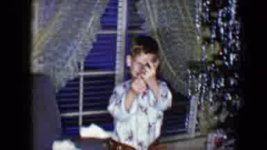 Disneyland California (1959): A Young Child In His Pajamas Puts On A Gold Or Brass