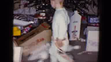 Disneyland California (1959): Boy Wearing Pale Green Pajamas Plays With