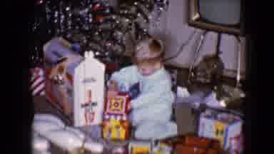 Disneyland California (1959): Child Sitting In Room By Christmas Tree Opening Up