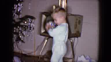 Disneyland California (1959): Young Boy Playing With A Ball Near A Christmas Tree