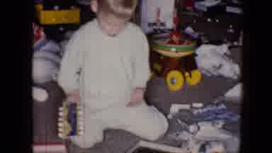 Disneyland California (1959): Little Boy Wearing Pajamas Sitting On A Floor As He