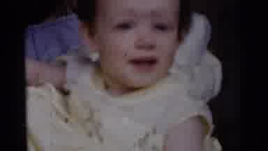 GARY INDIANA USA-1961: Little Child Smiling in Yellow Outfit, Woman Holding Newborn Baby