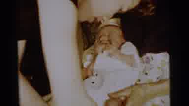 Gary Indiana USA (1961): Woman Helping To Put On Baby Booties For New Born Child