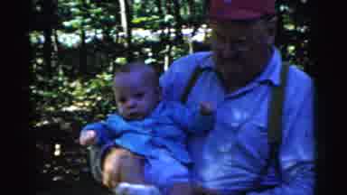 Gary Indiana USA (1961): A Man And A Woman Are Both Holding Babies Outside In A