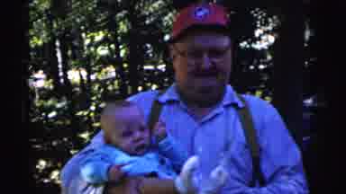 Gary Indiana USA (1961): Man Wearing Blue Shirt Holds Baby Wearing Blue Jacket