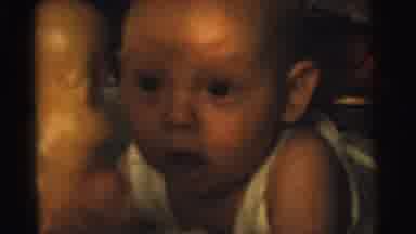 Gary Indiana USA (1961): Baby Wearing White Shirt Looks At Hand Of Person Shaking