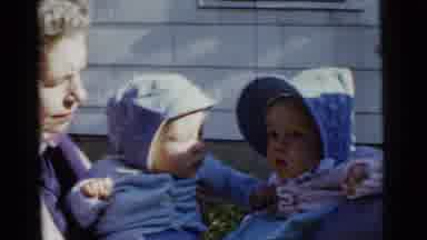 Gary Indiana USA (1961): Two Women Carry Babies Outside Wearing Blue Bonnets