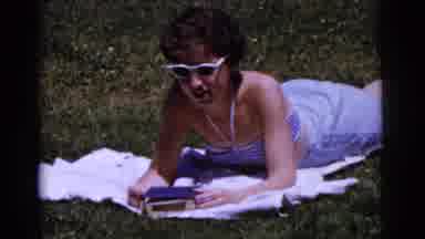 Gary Indiana USA (1961): There Is A Woman Laying On A White Blanket In A Green