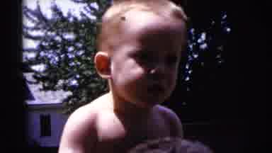 Gary Indiana USA (1961): A Toddler With Blonde Hair On The Shoulders Of Someone