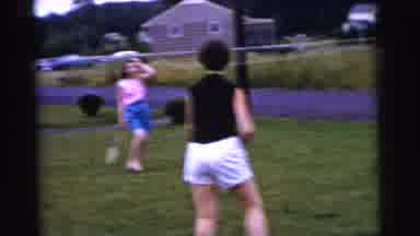 Gary Indiana USA (1961): Man And Women Play With Rackets Outside On A Cloudy Day