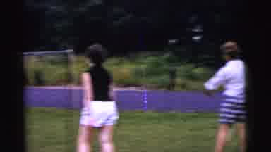 Gary Indiana USA (1961): People Are Playing Badminton On Grass Outside On A Sunny