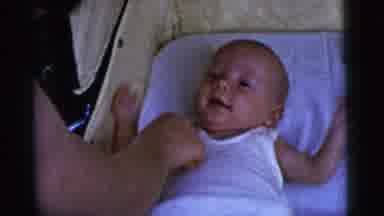 Gary Indiana USA (1961): Baby Laying In Crib While Person Tickles Baby In Various