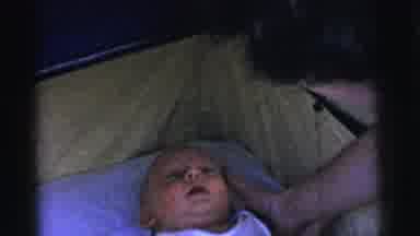 Gary Indiana USA (1961): A Baby In The Crib Apparently Being Tidied Up By His