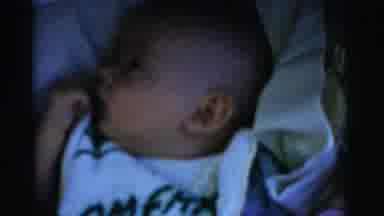 Gary Indiana USA (1961): Baby Wearing A White Bib Is Laying Down And Being Admired