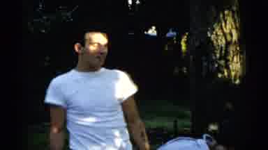 Gary Indiana USA (1961): A Caucasian Man In A White T-Shirt Talks To A Woman Who