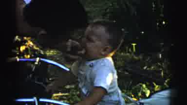 Gary Indiana USA (1961): A Man Jokes With A Baby By Having The Child Bite On His