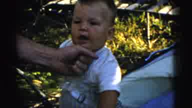 Gary Indiana USA (1961): Man Wearing White Shirt Holds Hand Under Chin Of Baby
