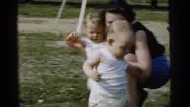 Gary Indiana USA (1961): A Mother Plays With Two Babies Outside On A Sunny Day