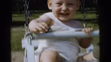 Gary Indiana USA (1961): On A Sunny Day, A Baby Is Enjoying A Swing In A Public