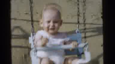 Gary Indiana USA (1961): Happy Toddler Giggles And Waves Her Hands While Swinging