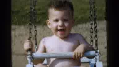 Gary Indiana USA (1961): Happy Smiling Little Boy Swinging In A Child's Seat On A