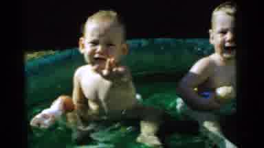 Gary Indiana USA (1961): Two Children In A Kiddie Pool Splashing Water On A Sunny