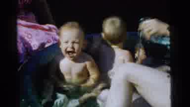 Gary Indiana USA (1961): A Man Plays With Two Babies In A Backyard Tub Pool