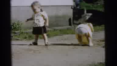 Gary Indiana USA (1961): A Small Child Is Walking Outside Next To A Second Child