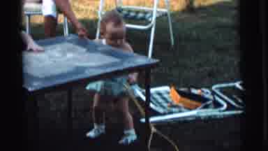 Gary Indiana USA (1961): Three Babies Play Outside While One Of Them Pushes A