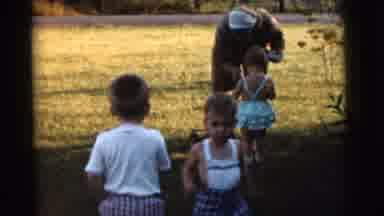 Gary Indiana USA (1961): Three Children Playing In The Grass And An Adult Tending