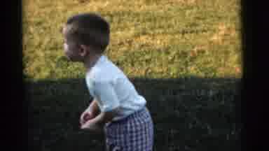 Gary Indiana USA (1961): A Child Laughing With A Red Ball In His Hand Follow By A
