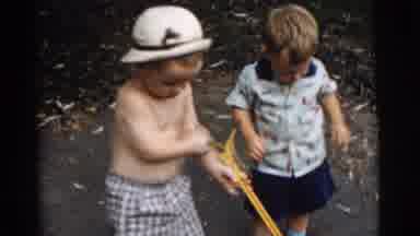 Gary Indiana USA (1961): Toddlers Play Outside With Yard Toys On A Sunny Day
