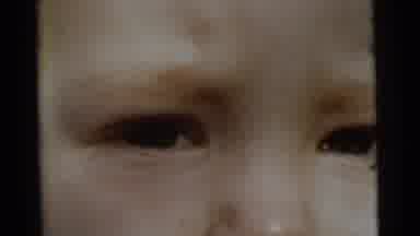 Gary Indiana USA (1961): Closeup View Of A Child Followed By A Woman In Green