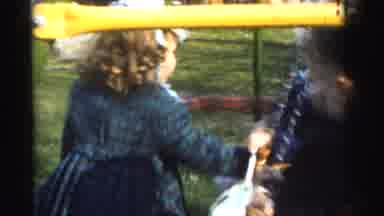 Gary Indiana USA (1961): Children Play Outside On The Swings As The Adults Sit