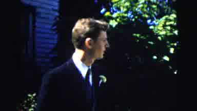 Moline Illinois USA (1962): Man In A Dark Suit Standing Outside Next To The Green