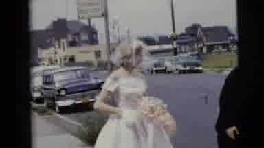Moline Illinois USA (1962): Two Brides Get Out Of A Wedding Car Holding Flowers