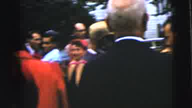 Moline Illinois USA (1962): Man Wearing Black Suit Stands Next To Woman Wearing