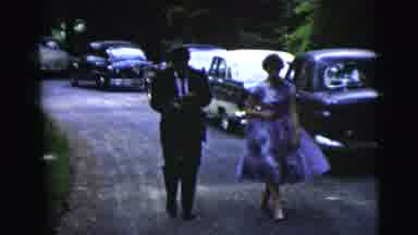 Moline Illinois USA (1962): A Man In A Suit And A Woman In A Dress Walking Down A