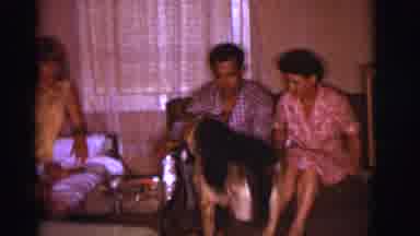 Clarkdale Arizona (1966): Four People Gathered In Room And Dog Coming Up To Them