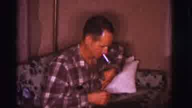 Clarkdale Arizona (1966): A Man Sits And Smokes While The Woman Smiles By Herself