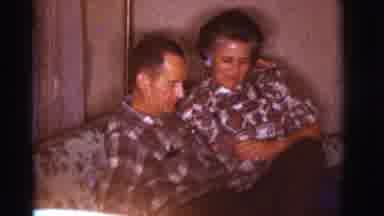 Clarkdale Arizona (1966): Man And Woman Sitting On A Couch Inside Giving Each