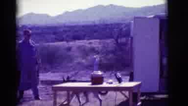 Clarkdale Arizona (1966): A Dog Is Walking Towards A Man With Some Mountains In